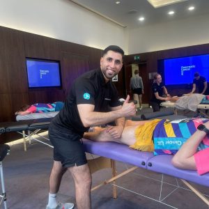 A sports therapist performing a sports massage