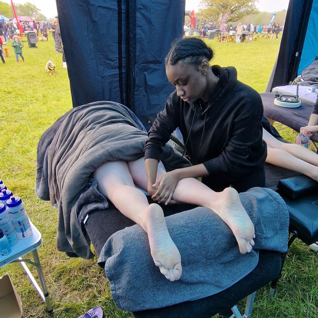 Chante performing post event sports massage at the spring wolf run 2024