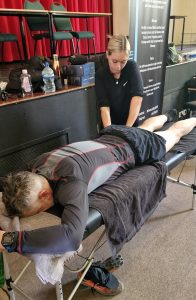 Mykala performing sports massage at the Malvern Hills Event